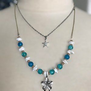 Handmade Beach Themed Puka Clam Shell Necklace with Plumeria Metal Charm Layered